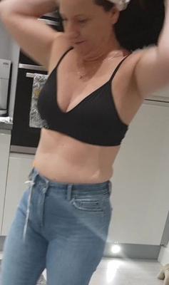 Mature milf with her arms up to show off her tiny boobs!