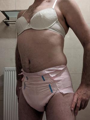 Again in pink diapers and a bra